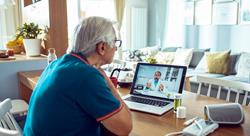 Close up of a senior man consulting with a doctor on his laptop