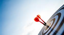 red dart hitting dart board with blue sky