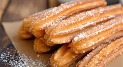 plate of churros with dipping sauce