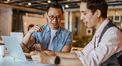 Two businessmen discussing over a document at modern coworking space