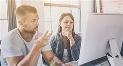 Man and woman coworkers discussing what they're seeing on a computer screen