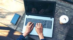 woman with hands on laptop keys