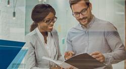 professional woman and man reviewing a document together