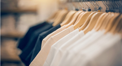 t-shirts on hangers inside a clothing store