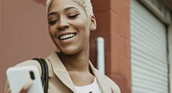 woman looking at her smartphone and smiling